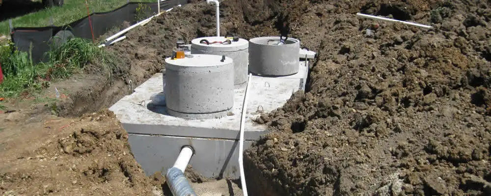 Septic system repair and installation site with tank access ports in Norton, MA