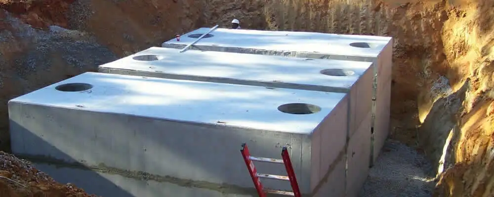 Septic tank installation site with a newly placed concrete tank in Norton, MA